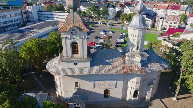 Low aerial forward shot approaching bell towers of Uspenia Church. autumnal vibe in Botosani, Romania