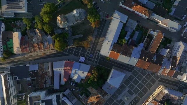 Top down spinning drone shot of Botosani old town, slow descend spin aerial in northeast Romania - 4k