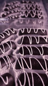 Decorate the cakes with white icing using a pastry bag. Vertical video