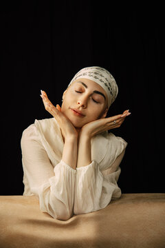 Portrait of a bald young woman with natural beauty and confident expression, isolated on neutral background. Concept of individuality, strength, self-acceptance, oncology awareness, alopecia