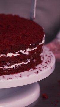The process of making sponge cake. The concept of making confectionery desserts. The pastry chef applies the cream to the cakes.