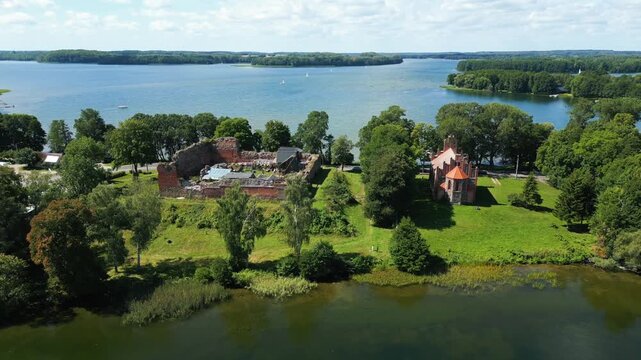 Aerial perspective of the Drahim castle ruins and the gothic Saint Hedwig chapel, historic landmarks on the shore of Lake Drawsko