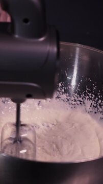 Using a mixer, beat the curd cream for the cake. The concept of making confectionery desserts.