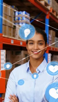Vertical video: Woman posing in warehouse aisle as icons appearing connecting lines mapping stock