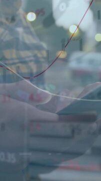 Vertical video: Man tapping phone on bus, causing market charts overlaying phone, tracking stocks