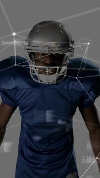 Vertical video: Sports pro adjusting mask, shouting and gripping ball prepping charge, HUD orbiting
