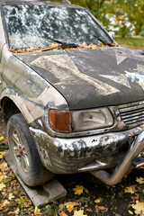 A damaged military SUV jeep in tactical paint © Denys