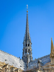 A vertical perspective of the newly reconstructed 96-meter lead-covered spire (flèche) topped with its golden cockerel of Notre-Dame cathedral in Paris, France © JeanLuc Ichard