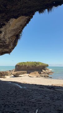 Sea cave view of Pancake Rocks in Punakaiki, West Coast, New Zealand. Layered limestone rock formations on the South Island coastline.