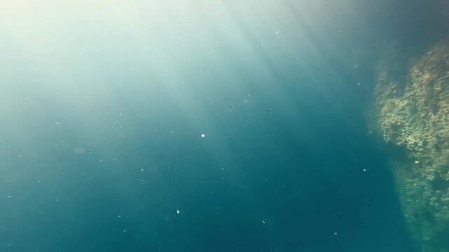 Ethereal Sunbeams Piercing Deep Blue Mediterranean Sea Near Gozo Malta During Radiant Summer Afternoon Creating Mesmerizing Light Patterns In Crystal Clear Water From Below Low Angle Perspective