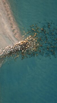 Roccella Ionica Beach with Calm Sea in Summer at Sunset in Italy