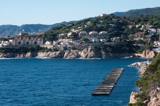 View of Sant Feliu de Gu&iacute;xols and Ermita de Sant Elm on sunny summer day. Girona, Spain.