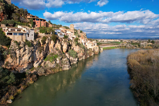 Aerial view of Miravet town and Ebro river on sunny day. Tarragona, Spain.