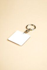 Blank White Keychain Mockup with Metal Ring on Neutral Background
