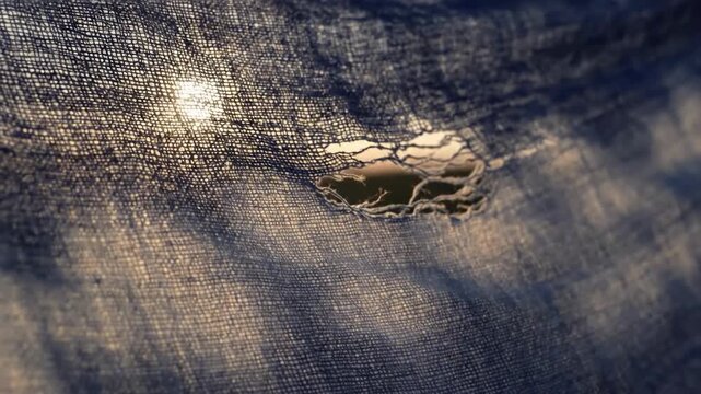 This close-up shot of distressed denim evokes a sense of wear and resilience. Perfect for concepts of texture, imperfection, or vintage style in desig