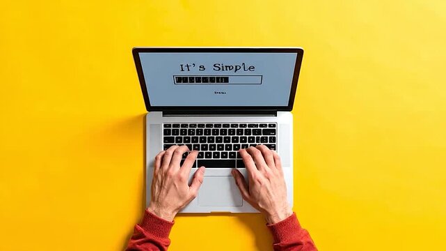 Overhead view of hands typing on a laptop with 'It's Simple' message.