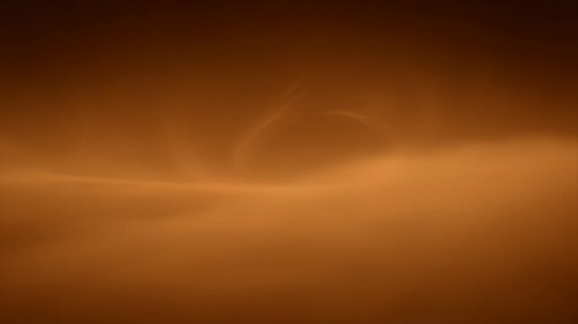 Smooth amber gradient background with subtle cloudlike wisps of light