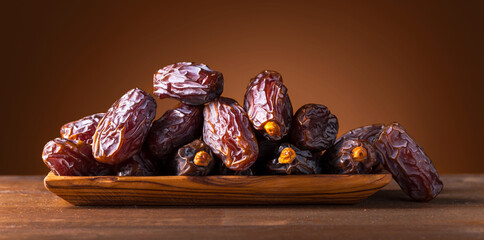 Juicy ripe dates on an old wooden table.