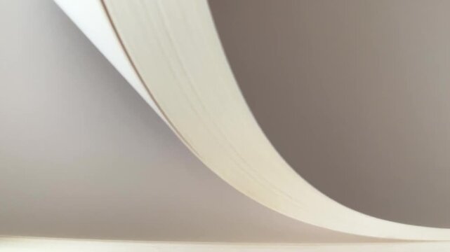 Close-up abstract view of stacked white paper sheets with soft lighting and gentle curves, flipping pages