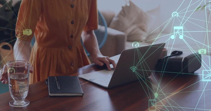 Animation of network of connections with media icons over caucasian woman using laptop