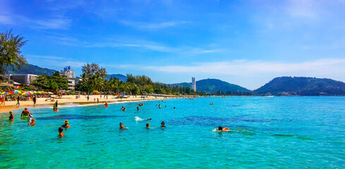 Tropical Patong Kamala Beach Phuket Thailand tourists people parasol palm. © Arkadi