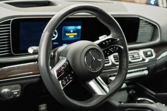 Mercedes-Benz GLS 63 AMG II X167 V8 Biturbo - interior, steering wheel, badge, front seats, central console panel, shift knob, dashboard. Black leather car interior. German premium SUV car.
