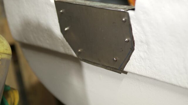 Cutting steel plate on boat transom using angle grinder