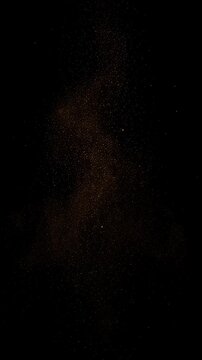 Deep darkness, abstract black background, profound mystery. Faint orange glow from void casts subtle shadow, peaceful night. Dazzling golden particles explode. Fiery orange dust creates energetic