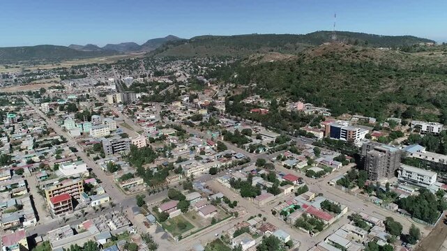 Aerial Trucking Shot Moving Towards Modern Aksum City Center and Urban Skyline, Tigray, Ethiopia
