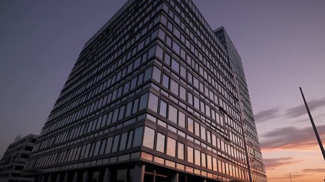 Modern 4K footage commercial glass office building reflecting clouds sunset hues symbolizing business urban architecture contemporary workplace es cinematic