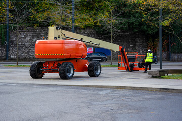 Boom lift and construction workers on urban street © FotoV