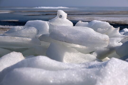 Piled ice on the shore of Baltic Sea in Puck Bay in early spring day. Oslonino, Pomerania, Poland