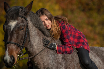 Fototapeta premium portrait of a girl with a horse