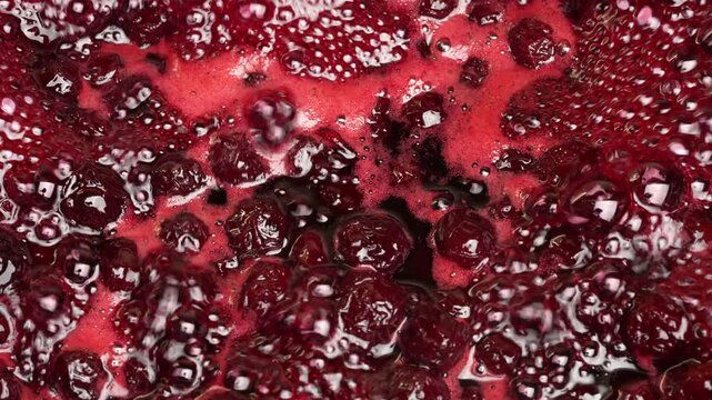 Preparing freshly picked red cherries with sugar to make cherry jam in a saucepan, close up. Cooking berries marmalade, home cooking