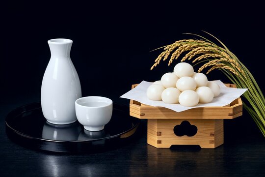 三方に美しく盛られた月見団子と稲穂に白磁の徳利と猪口が並ぶ十五夜のお月見イメージ