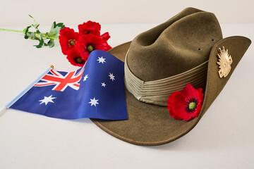 Slouch hat, poppies, and australian flag honoring anzac day