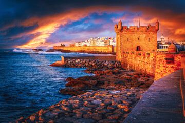 Dramatic sunset over Essaouira medieval fortress and Atlantic coast, Morocco
