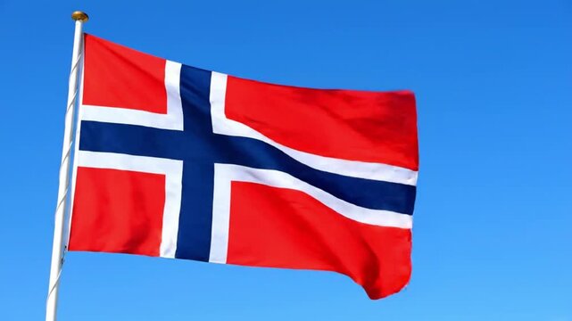 Norwegian flag waving on a pole against a clear blue sky