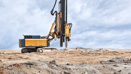A heavy-duty drilling rig installs bored piles at a construction site. Preparing the pile foundation for the upcoming reinforced concrete work