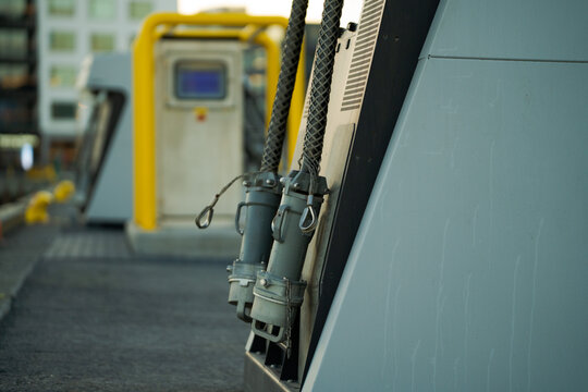 Close up of heavy-duty marine electrical cables and plugs for ship shore power.
