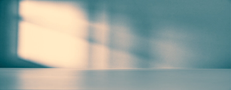 Banner of Minimalist empty room with soft natural light casting shadow on a wall. Clean, modern interior space for product presentation, with a beam of light falling into the room through the window