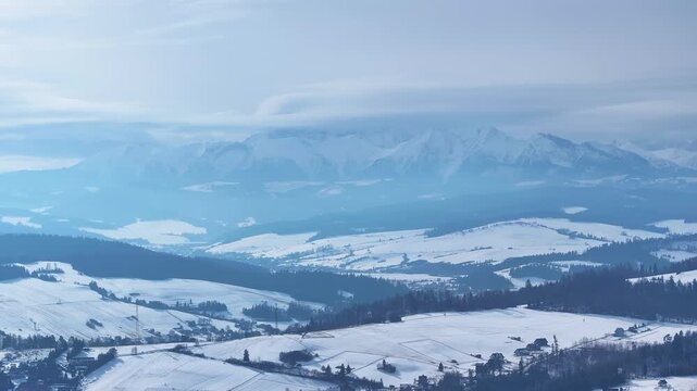 Aerial view of snow-covered mountains in winter landscape