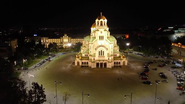 4K aerial night view of Bulgaria's capital Sofia. Iconic building. View of the Cathedral of St. Alexander Nevsky at nightfall, the largest church in the Balkans. Lateral movement. Streets and parks