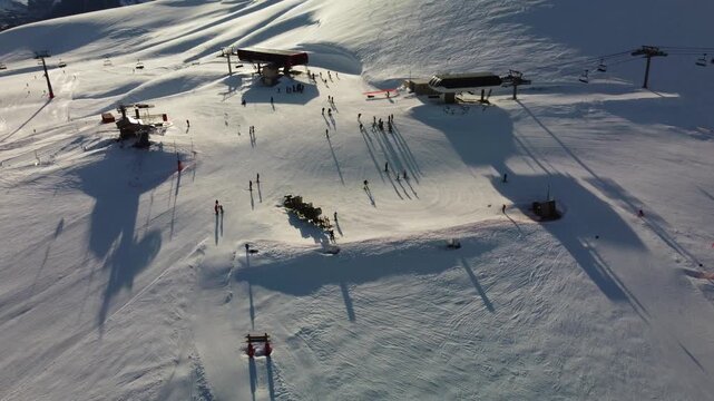 Converging ski lift installations in the French Alps - Orbiting aerial footage