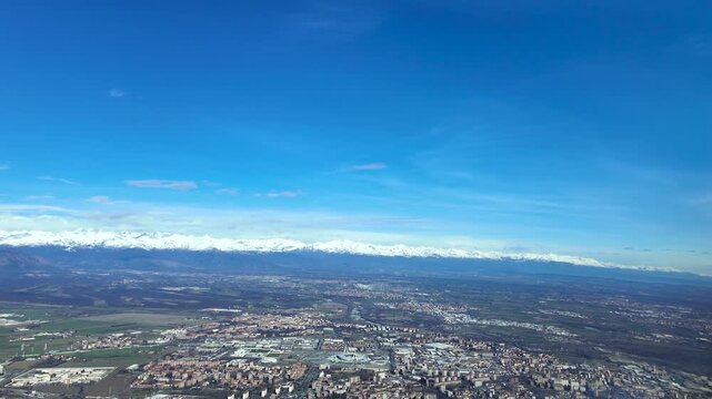 An immersive pilot&rsquo;s perspective in the final approach to Turin airport (TRN) in a bright winter day with the Alps Mountains peaks covered by snow.