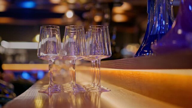A clean glass goblet. Beautiful clean glasses in a bar and restaurant. Thin glass goblet. Elegant look. Light reflection in a glass goblet.