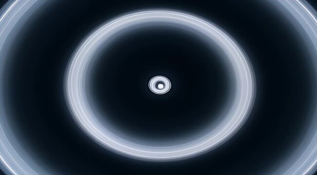 Abstract concentric circle pattern radiating from a central light source in darkness