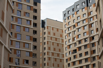 Exterior view of modern multi-apartment residential buildings under construction in an urban environment.
