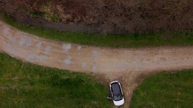 Vehicle navigates a crossroads, representing choices and journey, set amidst a backdrop of natural scenery.