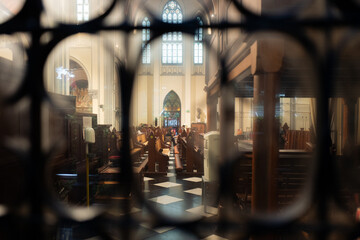 Artistic View of Jakarta Cathedral Interior Framed Through Ornate Wrought Iron Gate, Indonesia